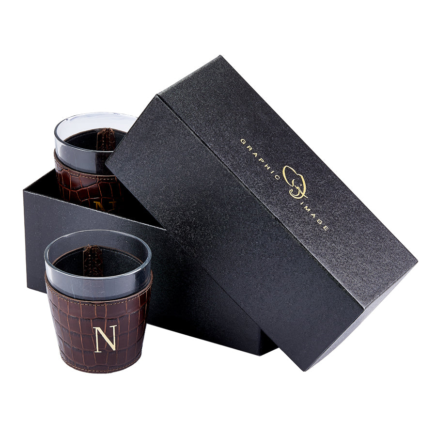 Two brown textured cups with a black lid in an open black box, featuring a brand logo.