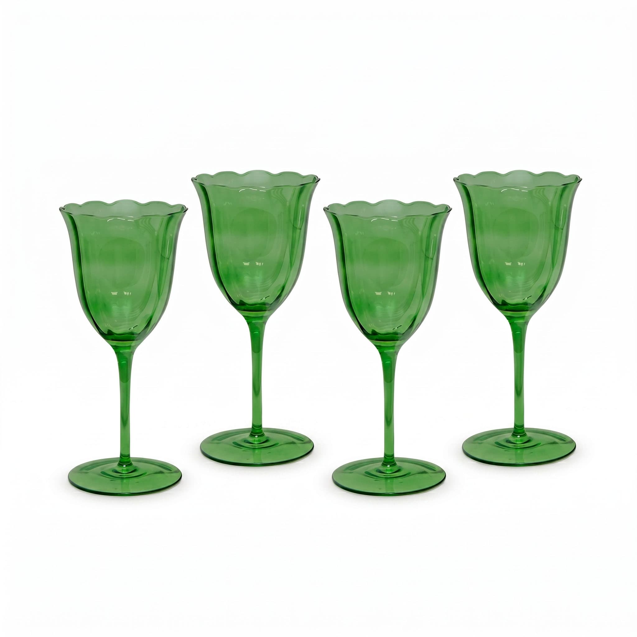Four green glass goblets on a white background