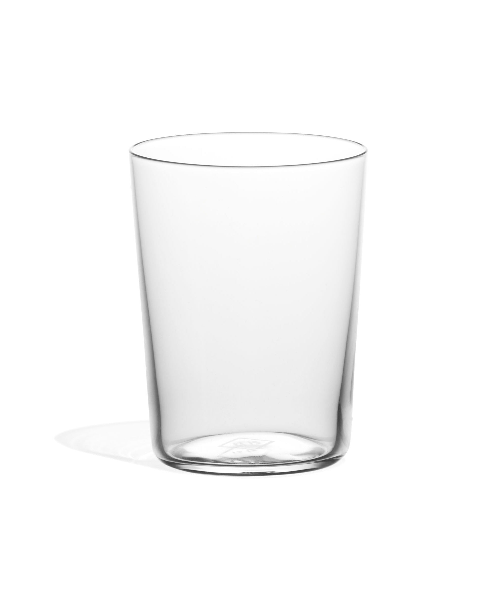 A clear glass shot glass with no visible contents, isolated on a white background.