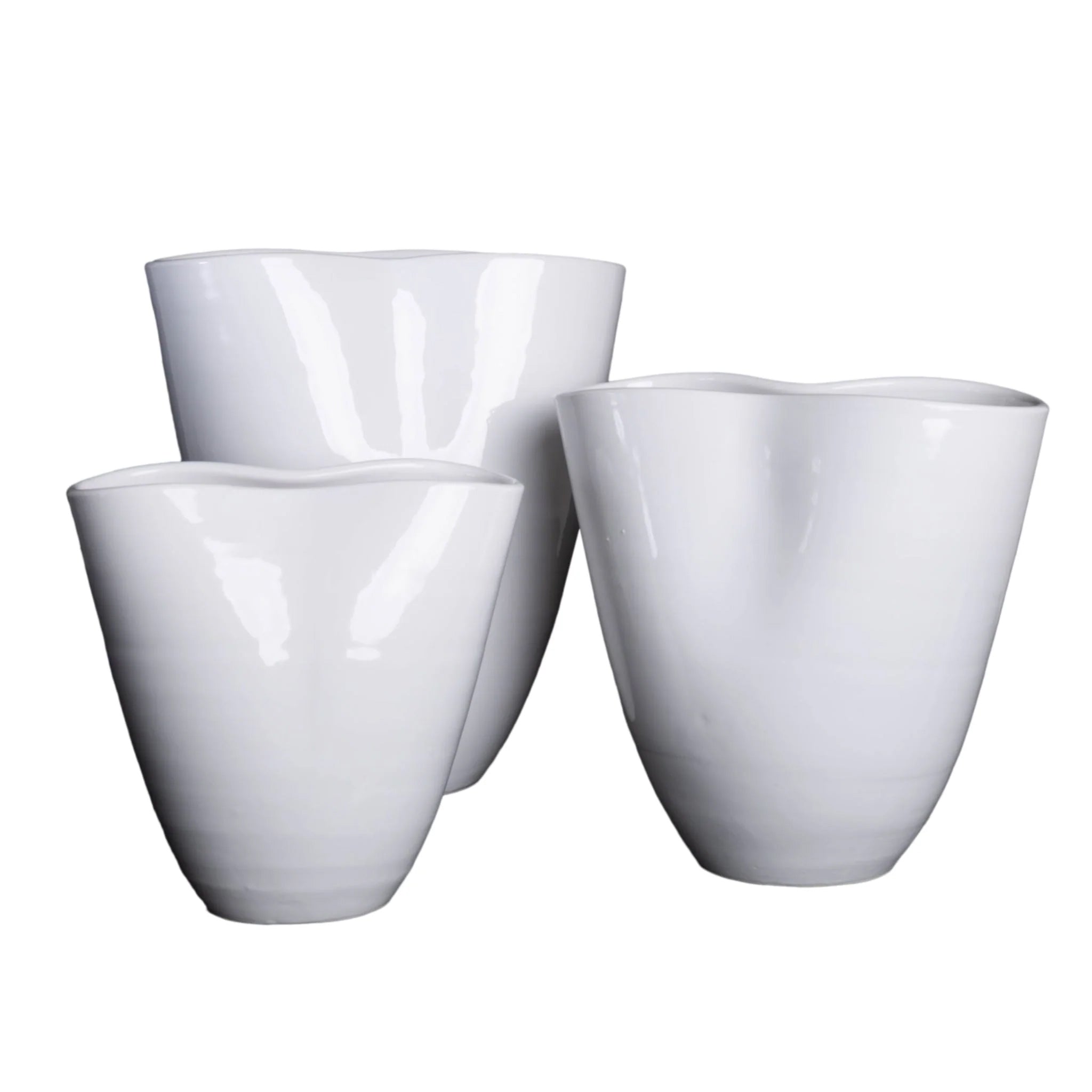 Three white ceramic planters on a white background