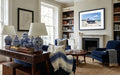 Living room with blue armchair, wooden coffee table, and bookshelves.
