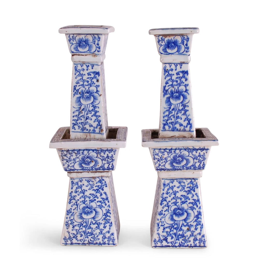 Pair of blue and white ceramic candle holders on a white background