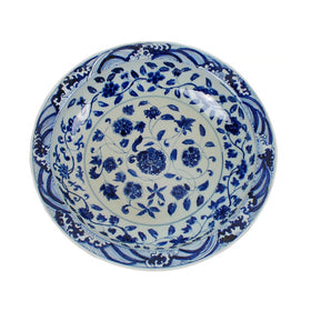 Blue and white floral ceramic plate on a white background