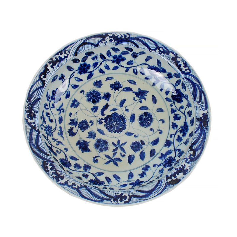 Blue and white floral ceramic plate on a white background