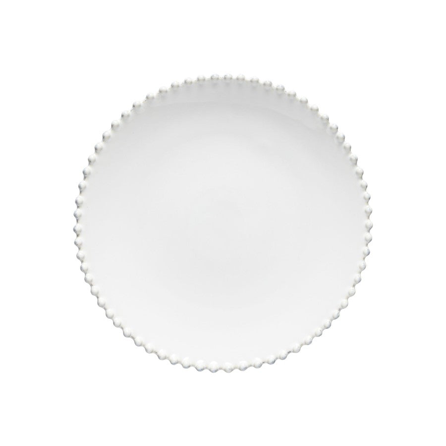 White plate with scalloped edge on a white background