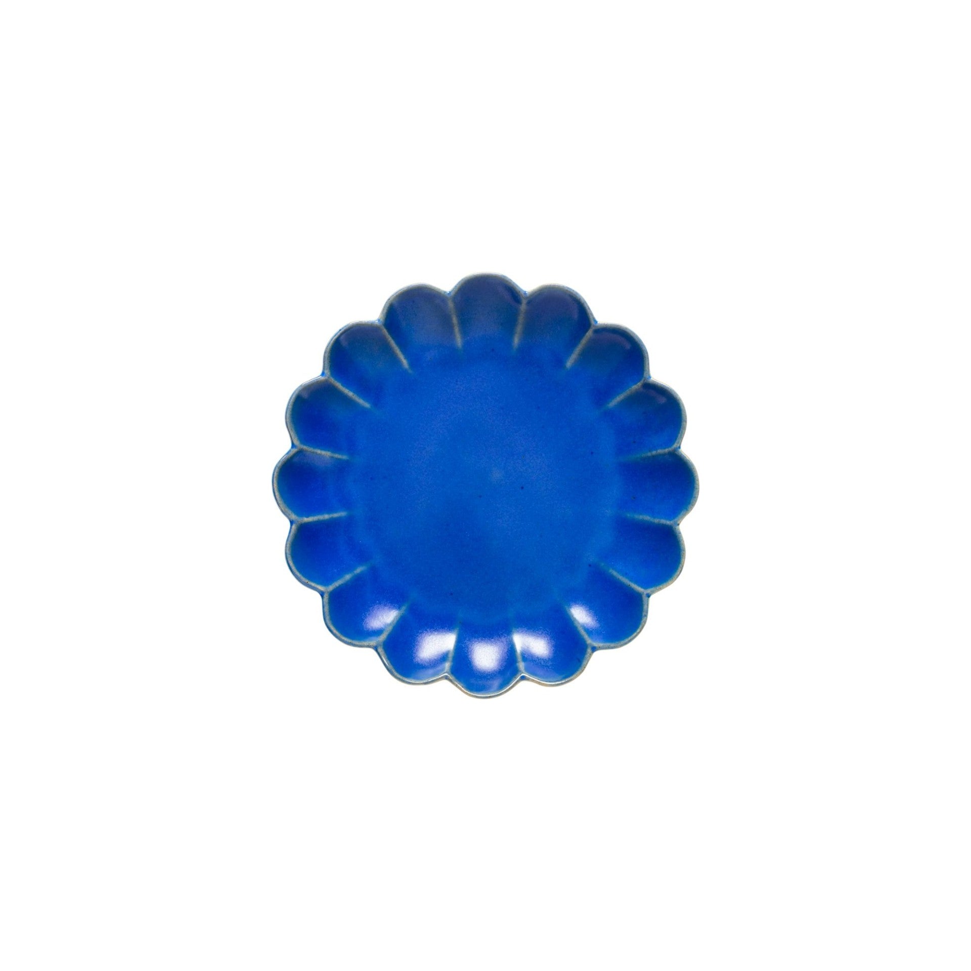Blue ceramic plate with a decorative edge on a white background