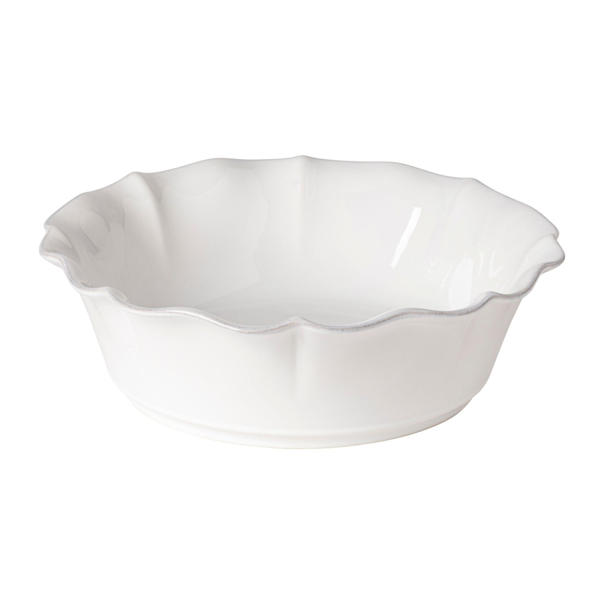 White ceramic bowl with scalloped edge on a white background