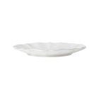 White ceramic plate with a textured edge on a white background