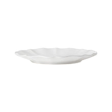 White ceramic plate with a textured edge on a white background