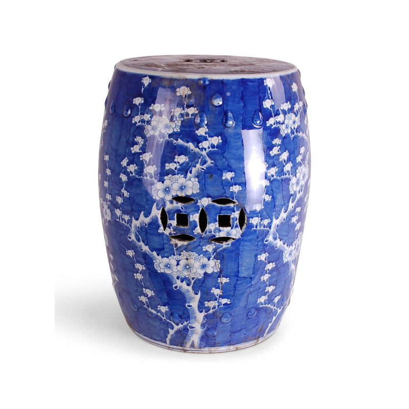 Blue ceramic vase with white floral patterns on a white background