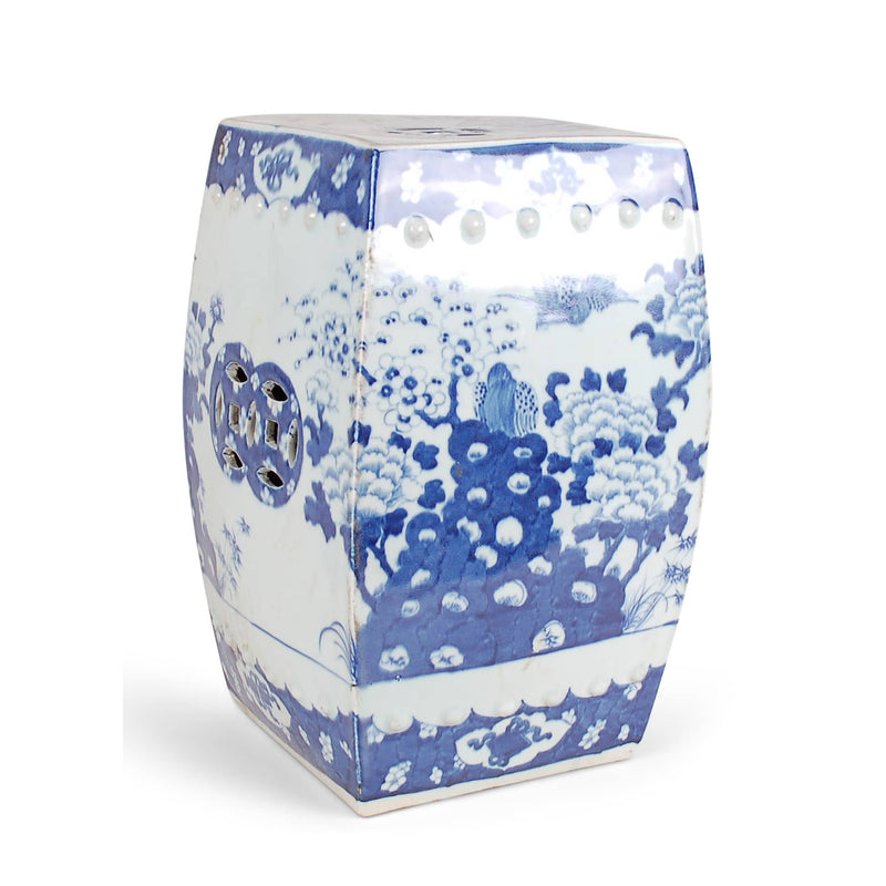 Blue and white ceramic garden stool with intricate patterns on a white background