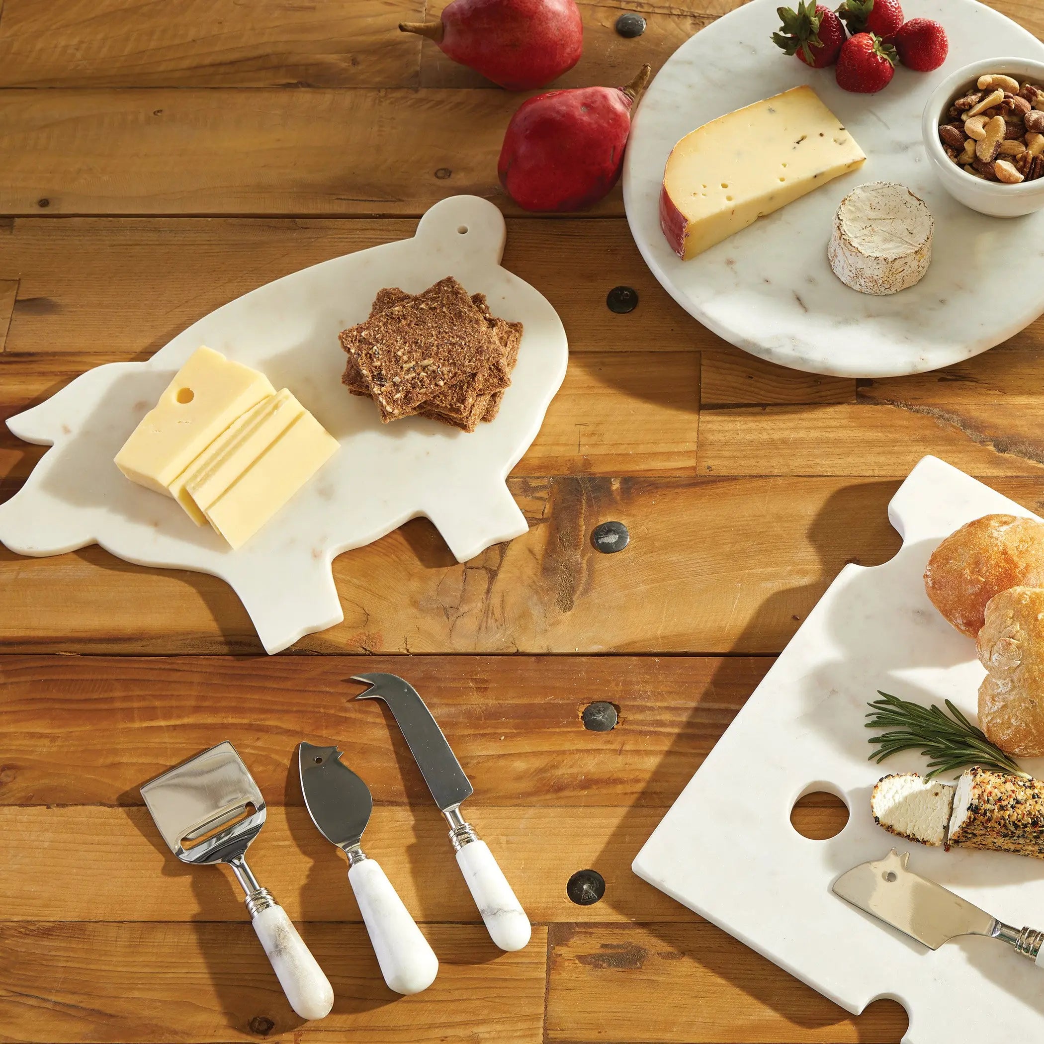 Cheese platter set with cheese, crackers, and bread on a wooden table.