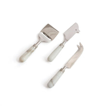 Set of three cheese tools with marble handles on a white background
