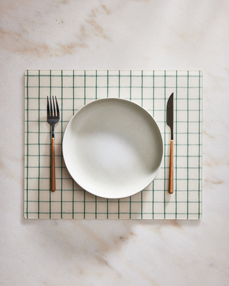 Rectangular placemat with a plate, fork, and knife on a marble surface