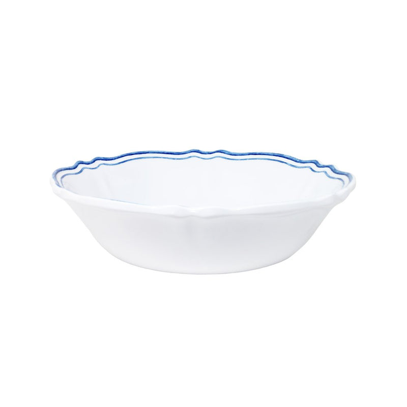 White ceramic bowl with blue rim on a white background