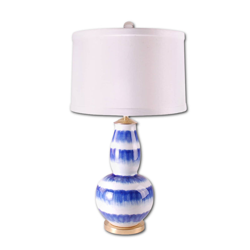 Table lamp with blue and white striped design on a white background