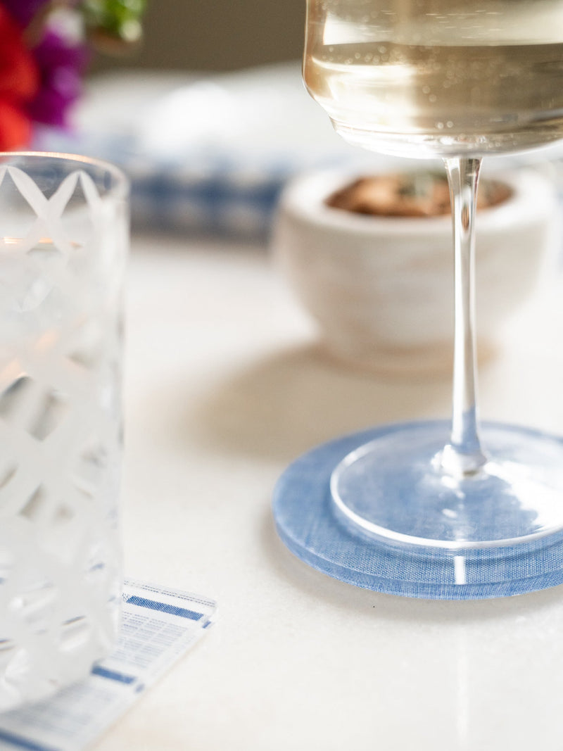 Glass of wine on a blue coaster with a blurred background
