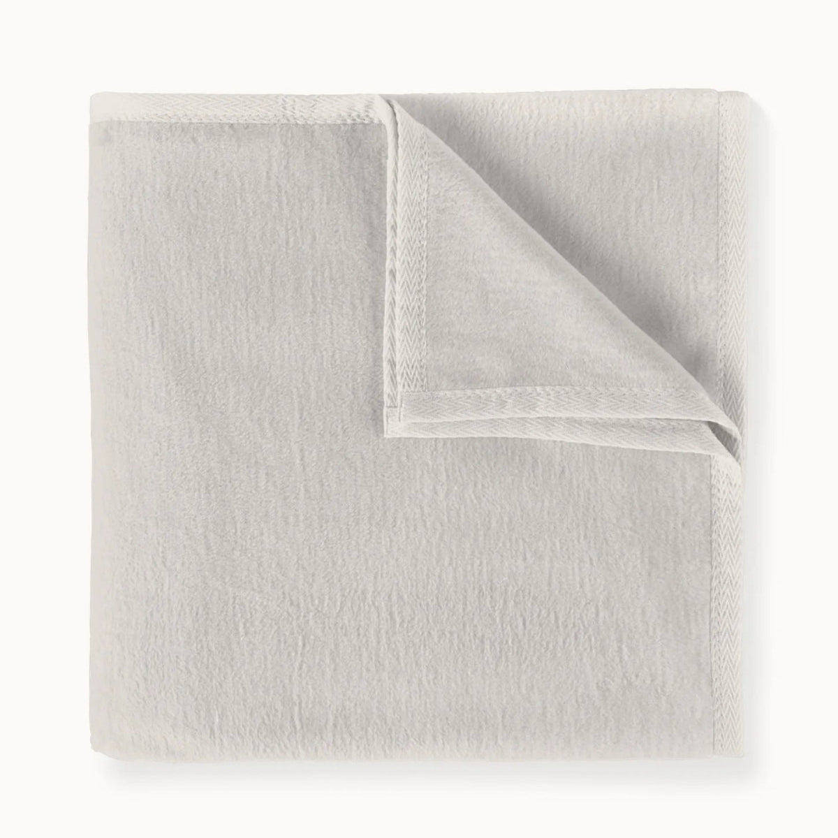 Folded light gray blanket on a white background