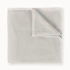 Folded light gray blanket on a white background