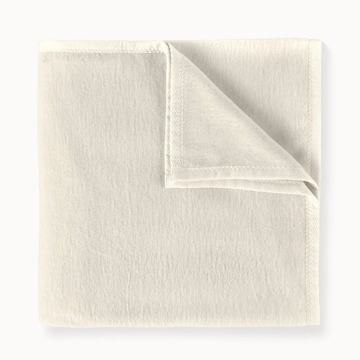 Folded beige fabric on a white background