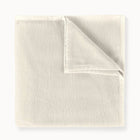 Folded beige fabric on a white background