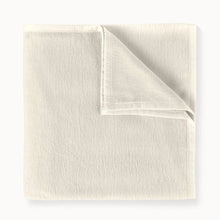 Folded beige fabric on a white background