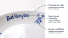 Close-up of a white ceramic plate or dish edge with blue 'East Hampton' lettering and blue architectural motif, with callout text explaining design features.