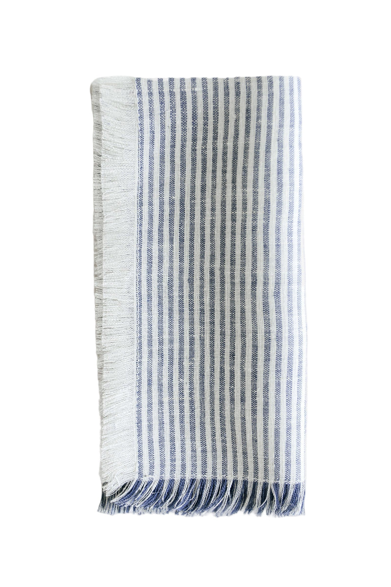 Linen fringe napkin with thin blue and white stripes on white background