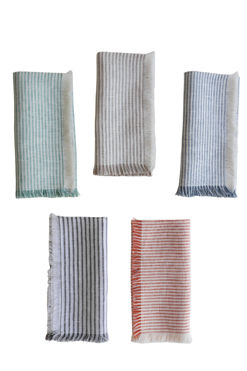 5 linen fringe napkins with thin stripes on white background: green/white, beige/white, blue/white, black/white, red/white