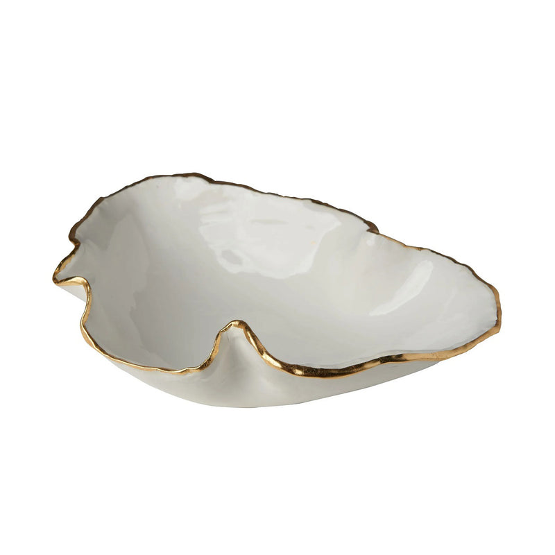 White ceramic leaf-shaped dish with gold rim on a white background
