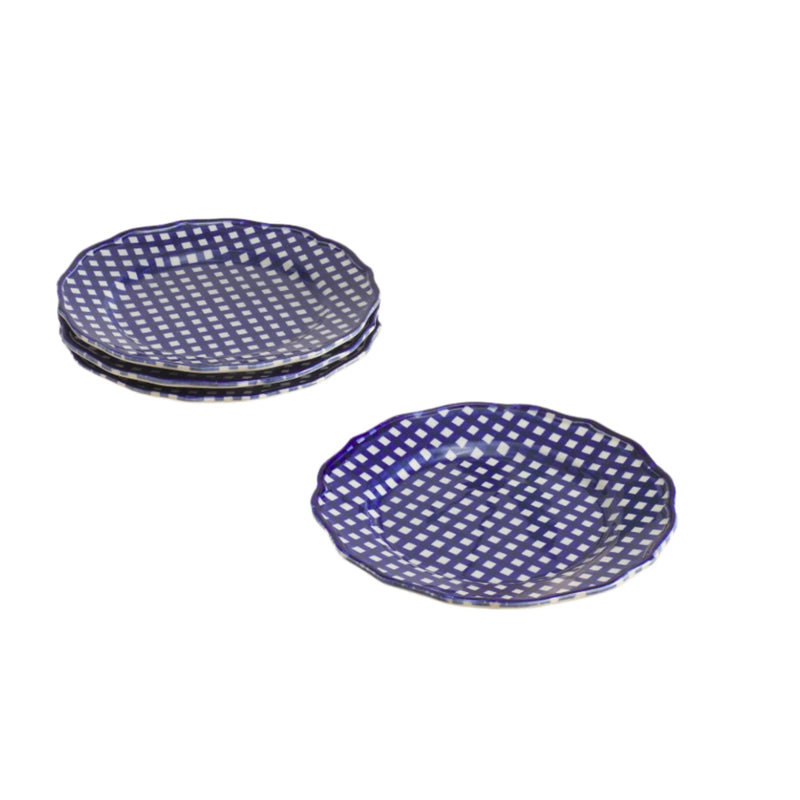 Set of blue ceramic plates with white pattern on a beige surface