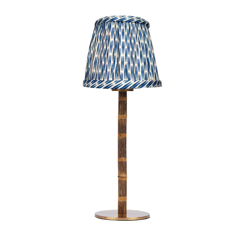 Lamp with a decorative blue and white patterned shade on a white background