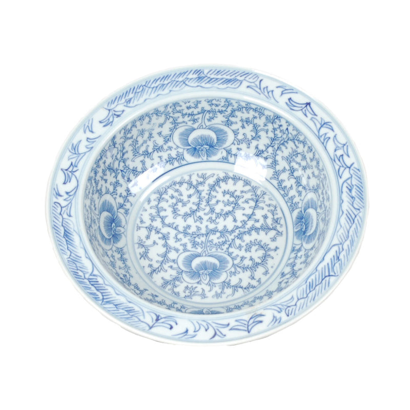 Blue and white ceramic bowl with intricate patterns on a white background