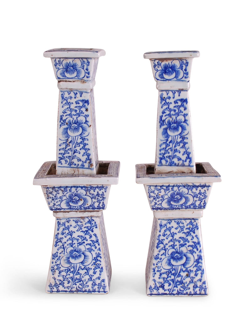 Pair of blue and white ceramic candle holders on a white background
