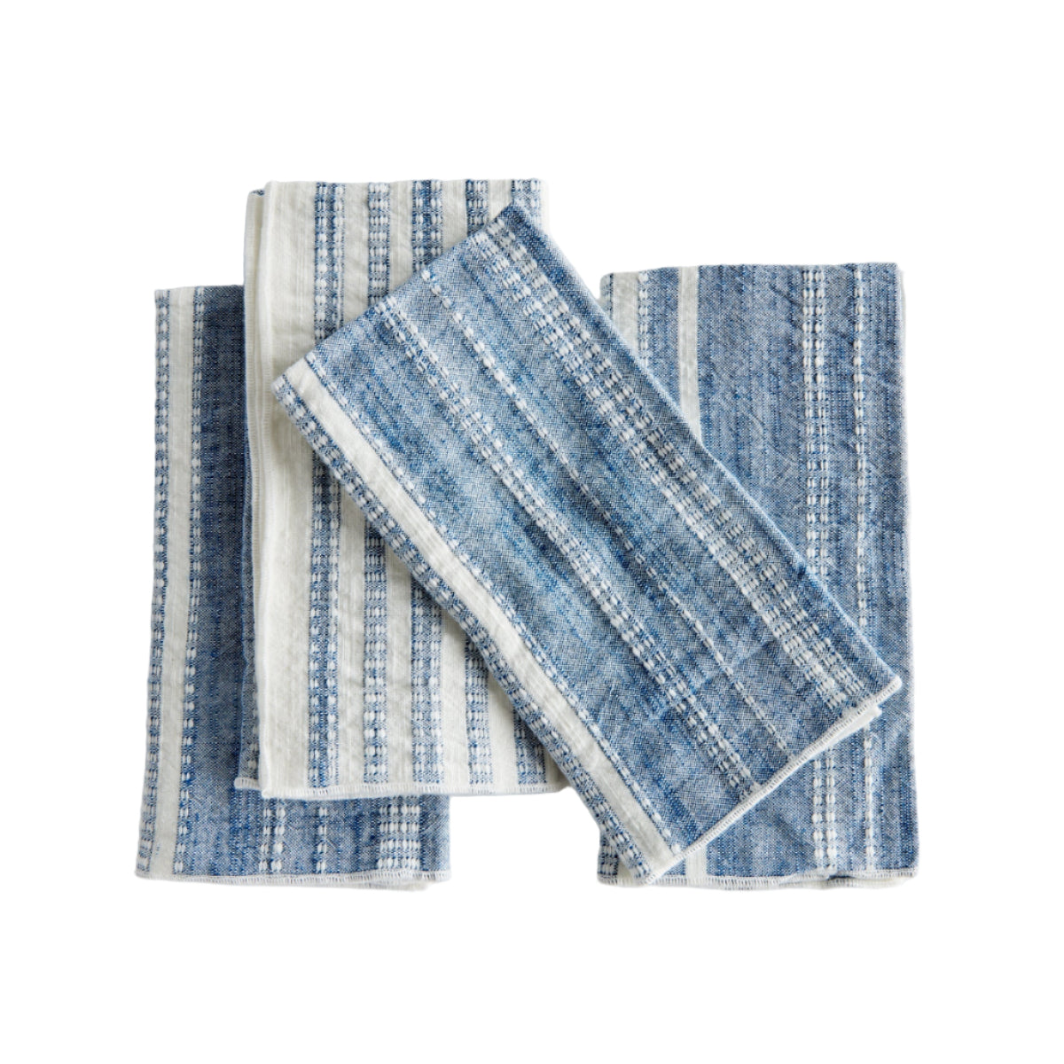 Set of blue and white patterned towels on a light gray background