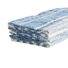Stack of blue and white checkered towels on a light gray background