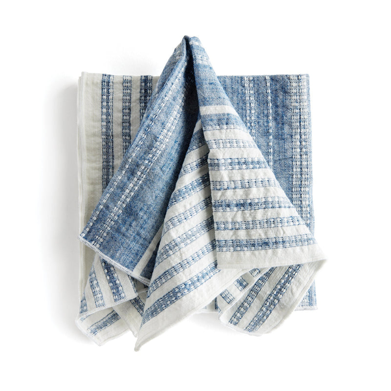 Set of blue and white striped towels on a white background