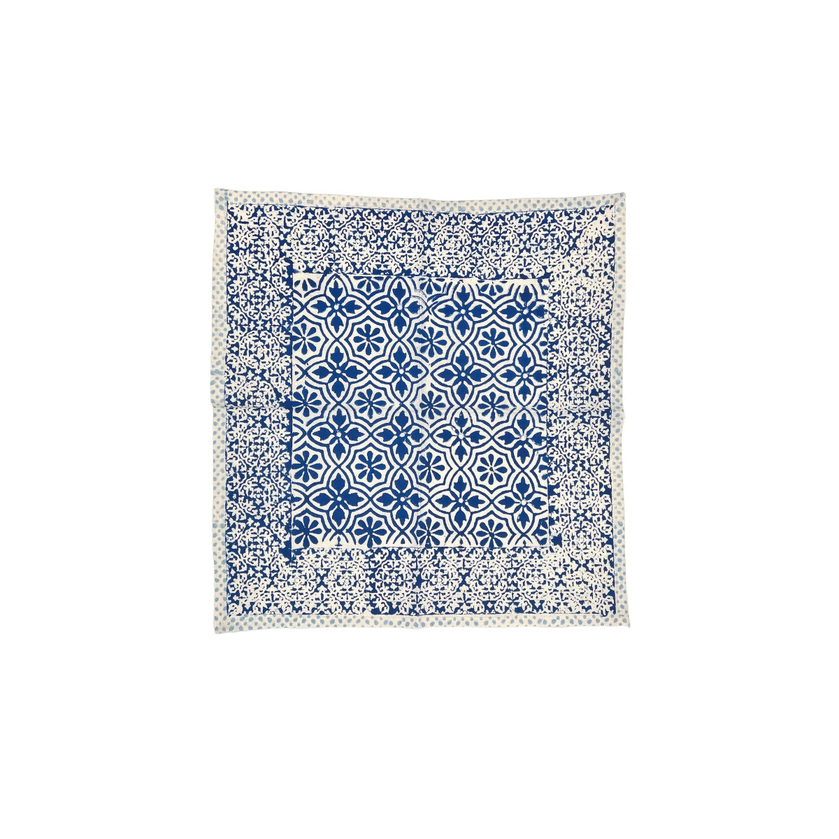 Blue and white patterned fabric square napkin on a white background