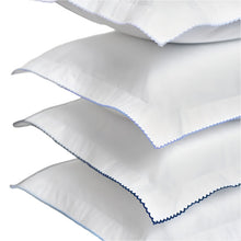 4 white fabric pillows with blue embroidery on a white background