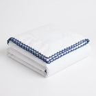 White handkerchief with blue lace trim on a white background