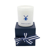 Candle in a white container with 'Hamptons Blue' branding on a navy box with a striped bow.