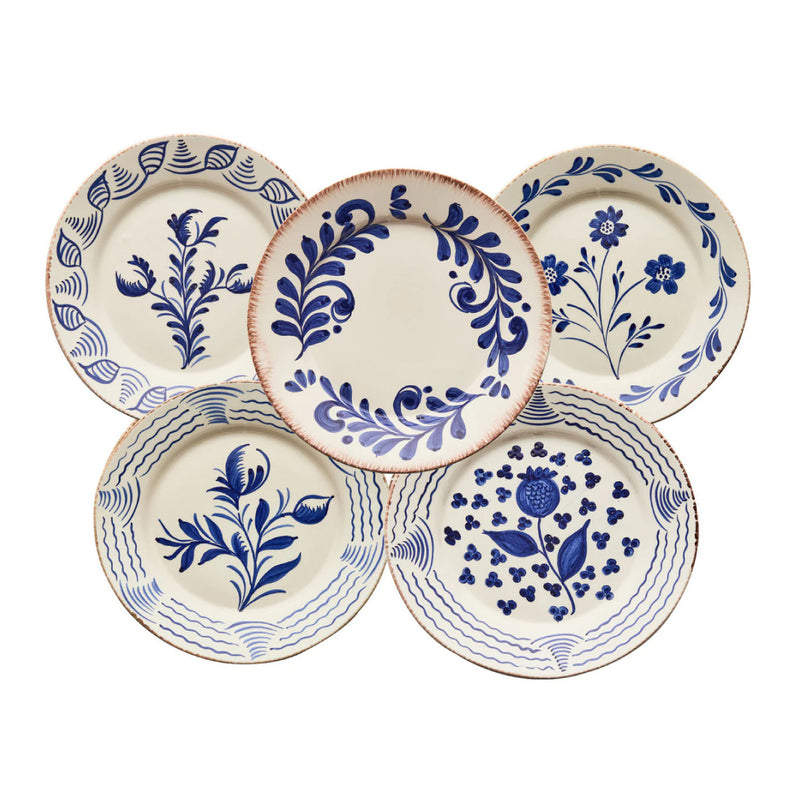 Set of five ceramic plates with blue floral and geometric patterns on a white background