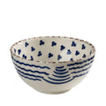Ceramic bowl with blue wave design on a white background