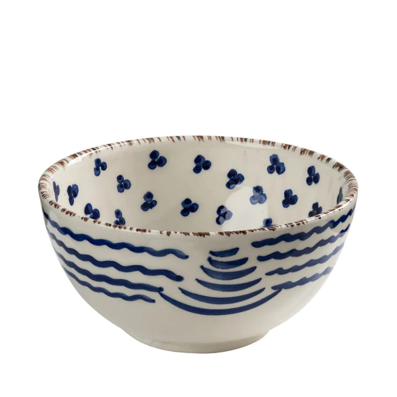 Ceramic bowl with blue wave design on a white background