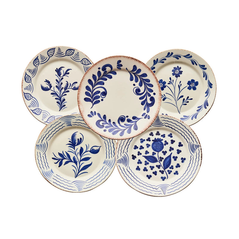 Set of five ceramic plates with blue floral patterns on a white background