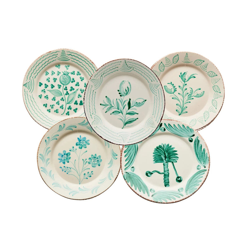 Set of five ceramic plates with floral designs on a white background