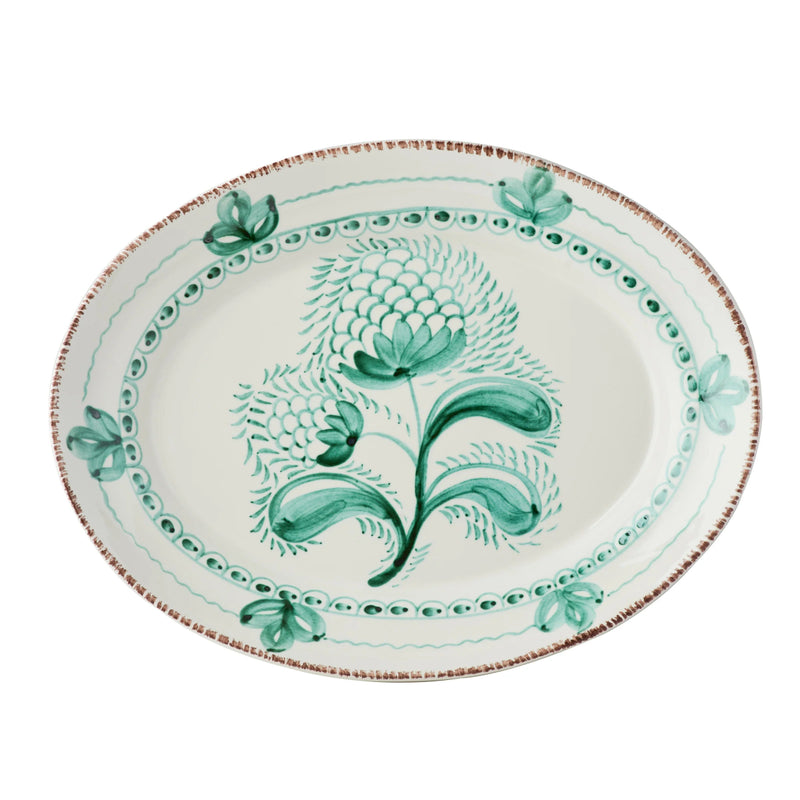 Decorative plate with green floral design on a white background