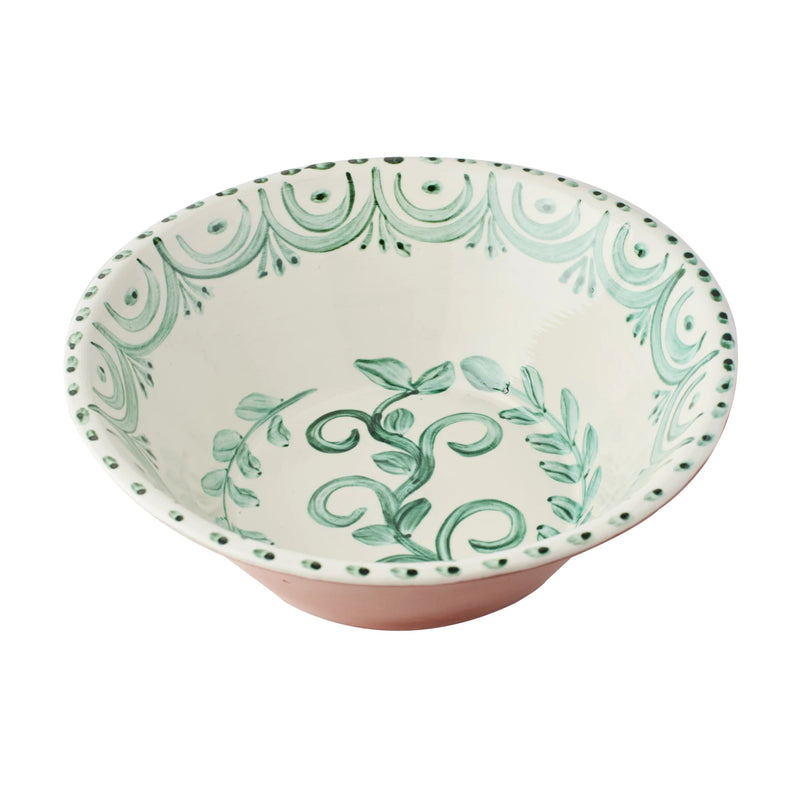 Ceramic bowl with green leaf pattern on a white background