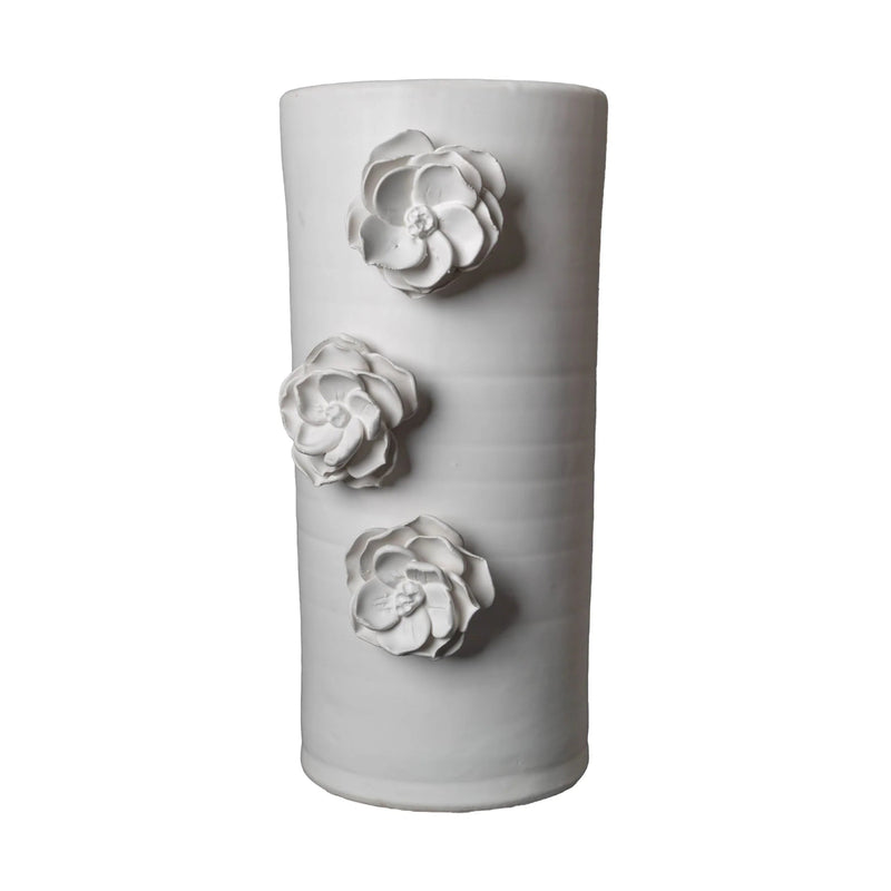 White ceramic vase with three floral designs on a white background