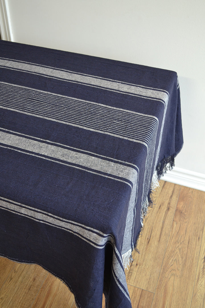 Navy linen tablecloth with white stripes on a table